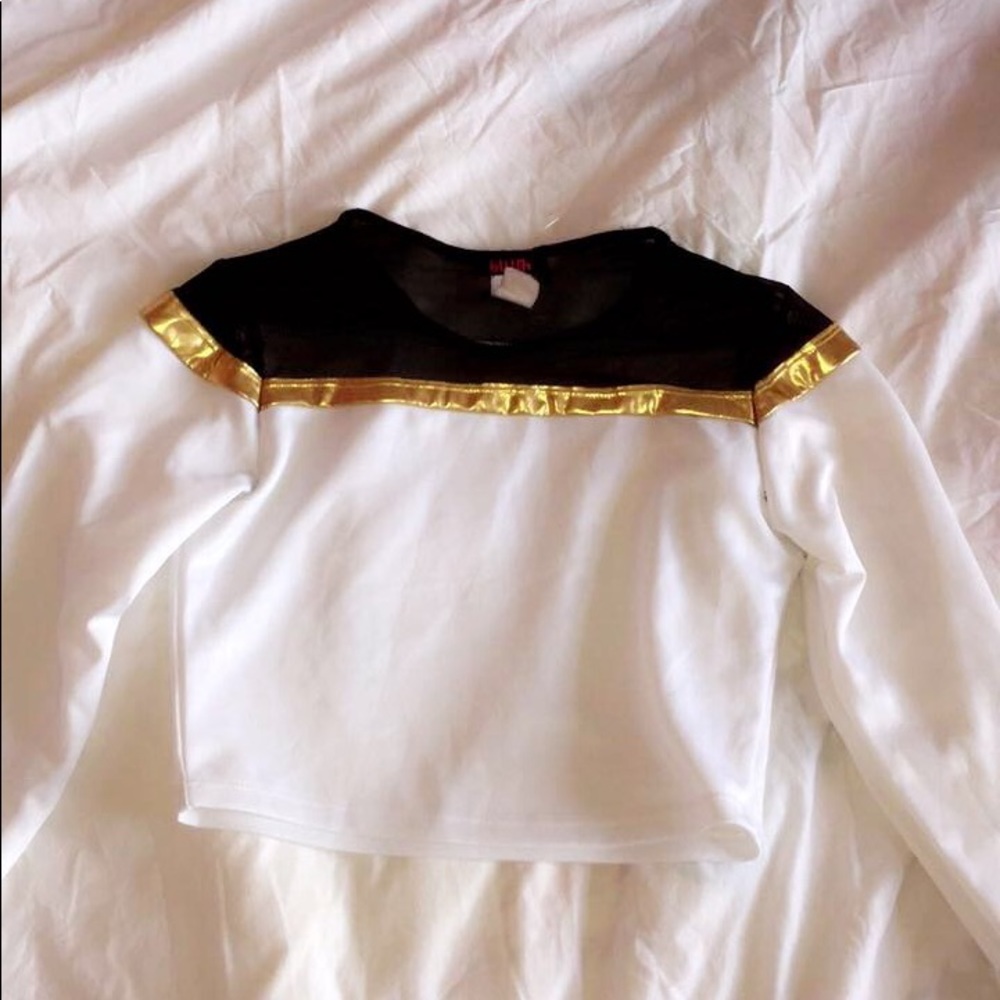 A white top with black and cold on top